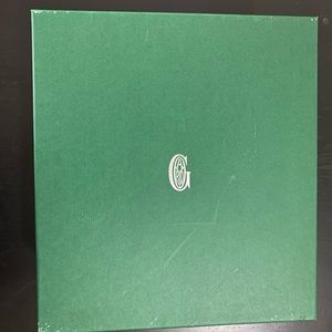 Goyard gift box with yellow tissue paper and tag